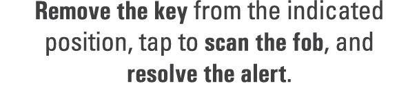 Remove the key from the indicated position, tap to scan the fob, and resolve the alert.